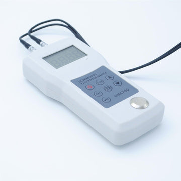 A close-up of the UM6700's probe on a flat metal surface, highlighting its precision.